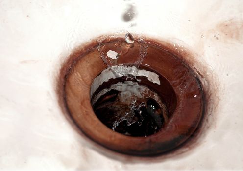 Waterdrops falling into vintage sink