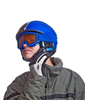 Teenage boy checking his helmet strap before heading down the slope.