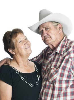 Elderly couple posing for an anniverary photo, arms around each other.