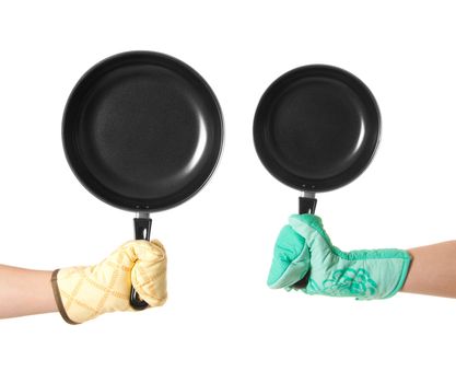 two hands in gloves holding pan's