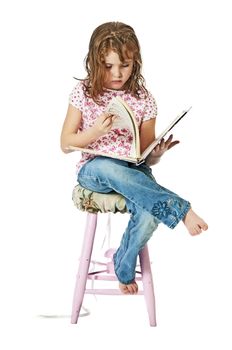 Little girl looking at a music book.