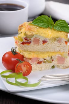 Omelet with vegetables and ham for breakfast close up