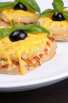 pieces of chicken   brisket a slice of pineapple with cheese  , olives and basil