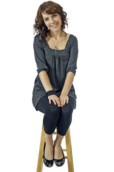 Smiling girl seated on a stool during an interview or audition for a movie part.