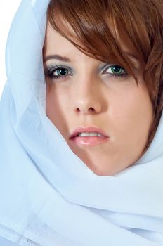 Beautiful young woman with a white scarf pulled around her head.