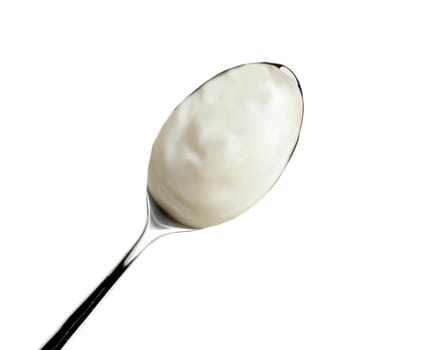 Spoon of yogurt isolated on white
