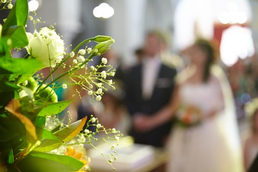 Wedding bouquet on a background of the bride and groom