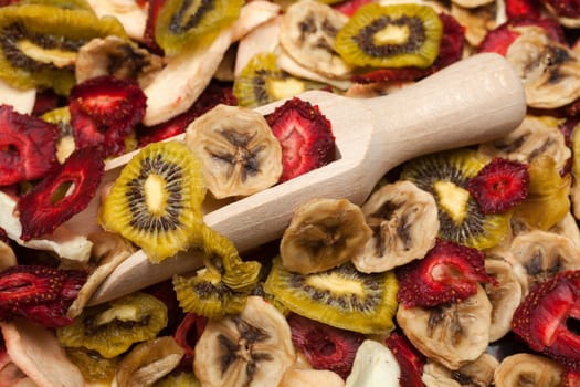 Different varieties mix of dried fruits with wooden scoop