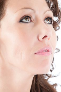 Pretty young woman looking up pensively.