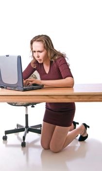 Pretty young woman determined to overcome difficulties working a computer program