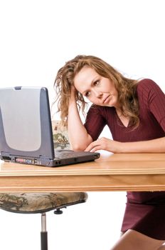 Young woman stymied by a program on her laptop computer