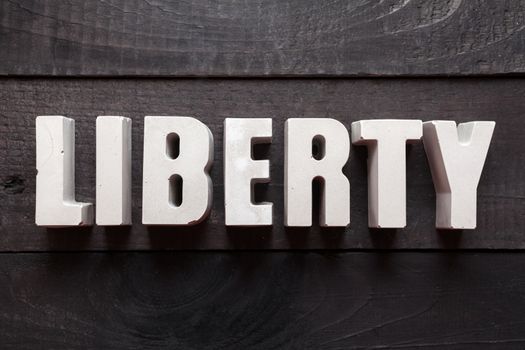 Letters from cement forming the word "Liberty"