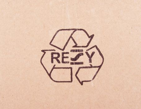 torn out piece of cardboard with recycle symbol