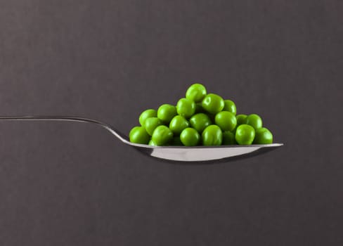 fresh frozen peas on spoon