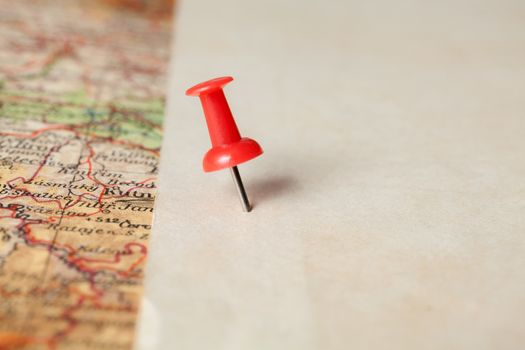 Red push pin showing the location of a destination point on a map. Ready for your message.