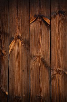 Brown vintage old wooden panel texture background with vertical unpainted aged planks and gaps and darker shaded border