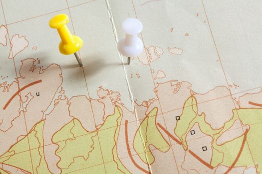 Push pins showing the location of a destination point on a map
