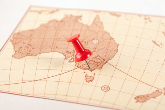 Red push pin showing the location of a destination point on a map. Australia