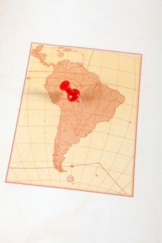 Red push pin showing the location of a destination point on a map. South America