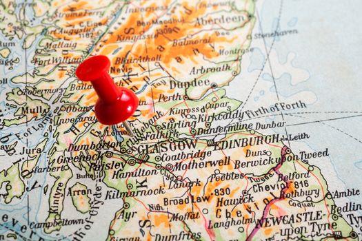 Red push pin showing the location of a destination point on a map. Glasgow