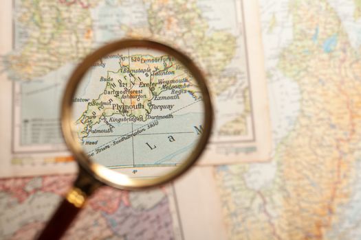 Magnifying glass in front of a Plymouth map