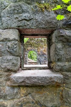 Looking through the window of abandoned stone castle house at Wildwood Trail in Forest Park Portland Oregon