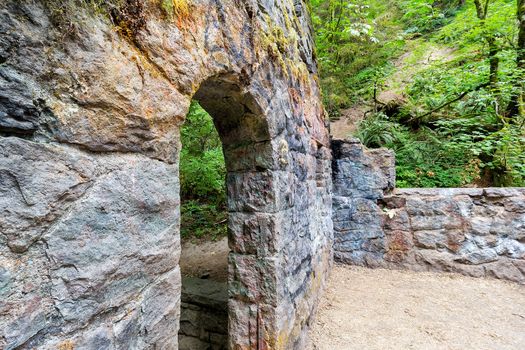 Abandoned stone castle house archway at Wildwood Trail in Forest Park Portland Oregon
