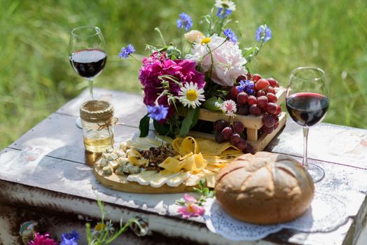 rustic decorative photo zone with suitcases, wine. cheese