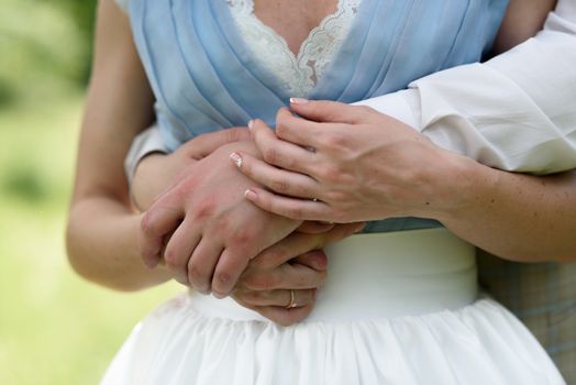 the hands of the bride and groom together