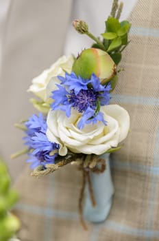the boutonniere on the groom's jacket