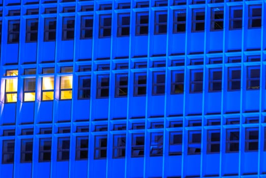 horizontal image of a Blue tall building with windows