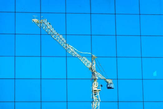 crane reflection over Window building in blue sky