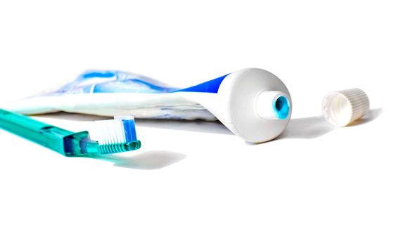 Toothbrush with an open tube of toothpaste isolated on white with a clipping path.