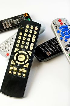 Various remote controls for television, satalitte reciever, stereo, sound system and vcr-dvd player.