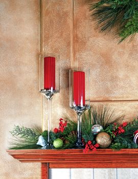 Fireplace mantle decorated with candles and garlands for Christmas. Cropped to standard Christmas card ratio