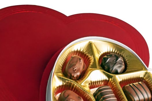 Open box of chocolate candy as a Valentine's Day gift isolated against a white background.