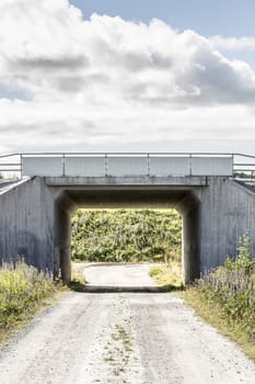 Tunnel Under Road with a cloudy sky.