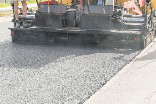 Asphalt Paver Laying Down Asphalt close up.