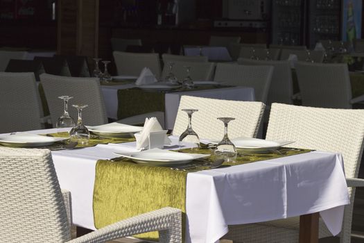 Laid table in restaurant.Empty tables and chairs in restaurant