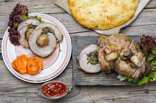 Dining table with meat loaf and pita bread