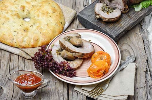 Dining table with meat loaf and pita bread