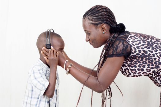 This child ask his mother to weat him helmet to also listen to music.