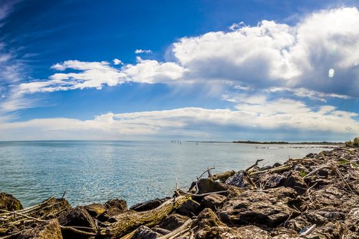 Rocks in front of the sea in a sunny but cloudy day in northern Italy