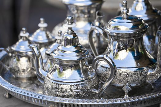 Table setting with silver tableware and dates. Oriental hospitality concept with tea or coffee cups