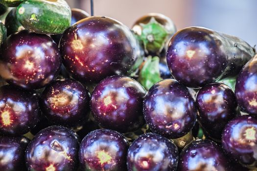 Group of many eggplants. Colorful eggplants. Eggplant texture. Pile of eggplants at French market. Purple eggplants. Eggplants wallpaper. Aerial aubergine view. Close up aubergine view.