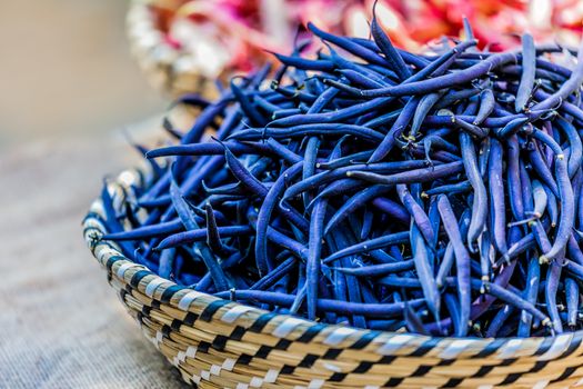 Green blu beans in a wicker basket at french market