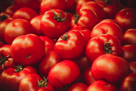 Fresh organic tomatoes at french market background texture