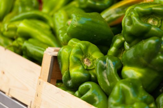 Green pepper in a wood basket at french market in summertime
