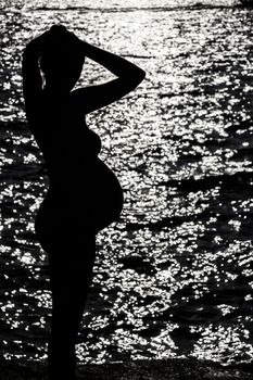 Silhouette of pregnant woman at the sunset at french riviera