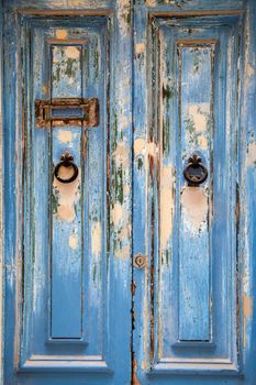 Blue weathered door with door knob and letter box